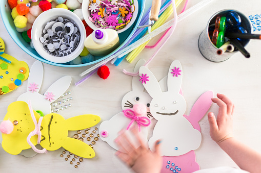 Step by step. Mother and daughter decorating Easter Bunnies.