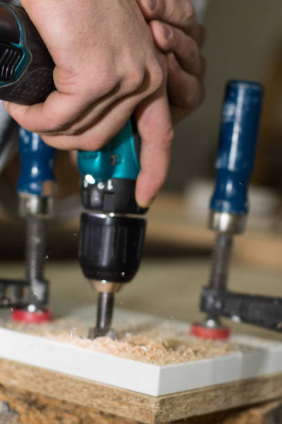 istock Building master with drilling machine. Professional carpenter working with wood 652652196
