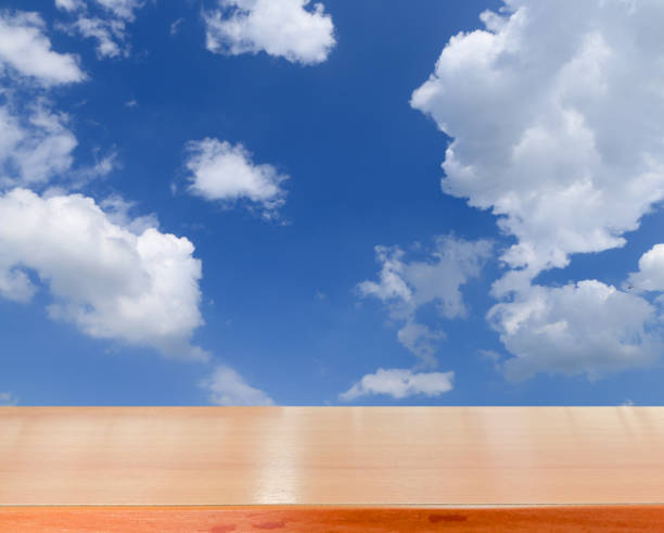 istock wooden tabletop with summer sky background 652663724
