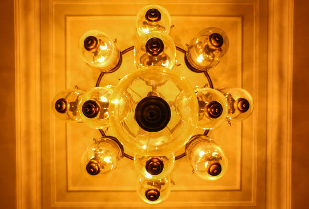 istock Yellow lamps with glass structure on ceiling in ballroom 652664354