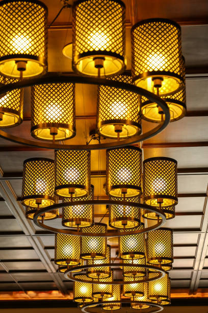 istock Yellow lamps with Cylinder  brass structure on ceiling in ballroom 652667292