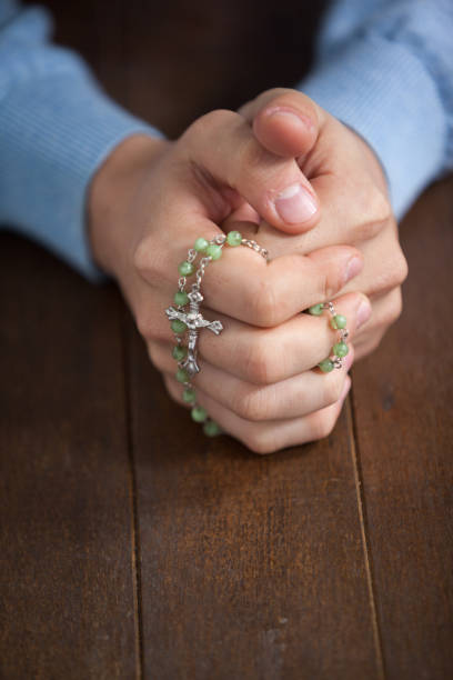 istock Praying hands of man with a rosary 652670570