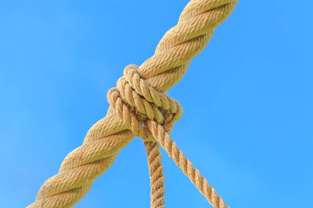 istock rope tied knot on blue background 652671526