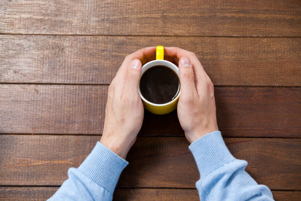 istock Man holding a cup of coffee 652682224