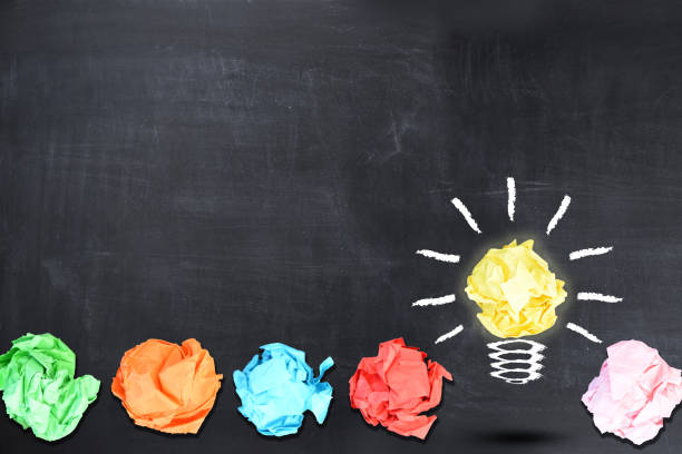 istock Bright idea concept with light bulb shaped crumpled paper on blackboard 652689246