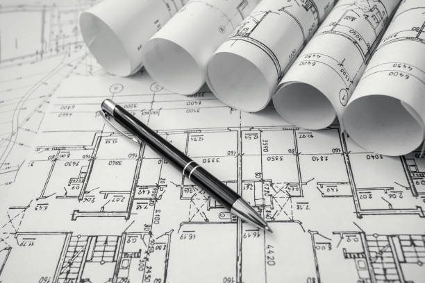 istock Architect workplace. Architectural project, blueprints, blueprint rolls on wooden desk table. Construction background. Engineering tools. Copy space 652692262