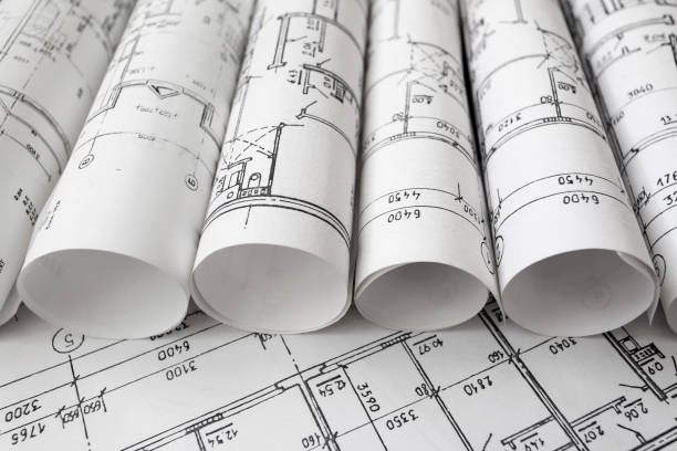 istock Architect workplace. Architectural project, blueprints, blueprint rolls on wooden desk table. Construction background. Engineering tools. Copy space 652692264