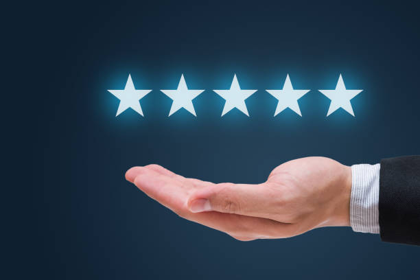 istock Businessman hand holding five stars isolated on blue background 652697736