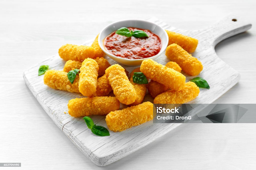 Breaded mozzarella cheese sticks with tomato basil sauce Breaded mozzarella cheese sticks with tomato basil sauce. Finger Stock Photo