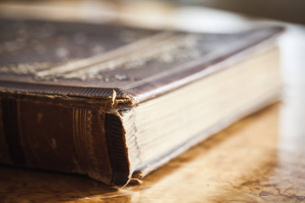 istock Closed vintage book lays on wooden table 652709216