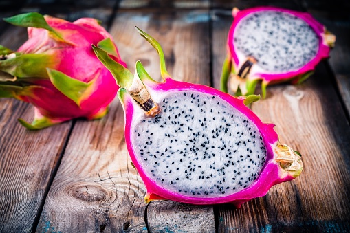 Tropical dragon fruit or pitaya on wooden rustic background