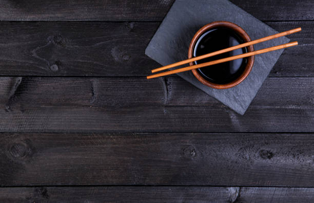 istock Background for sushi. Soy sauce, chopsticks on black stone. Top view with copy space 652717178