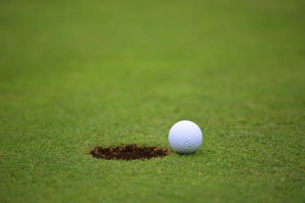 istock Golf ball on lip of cup 652718590