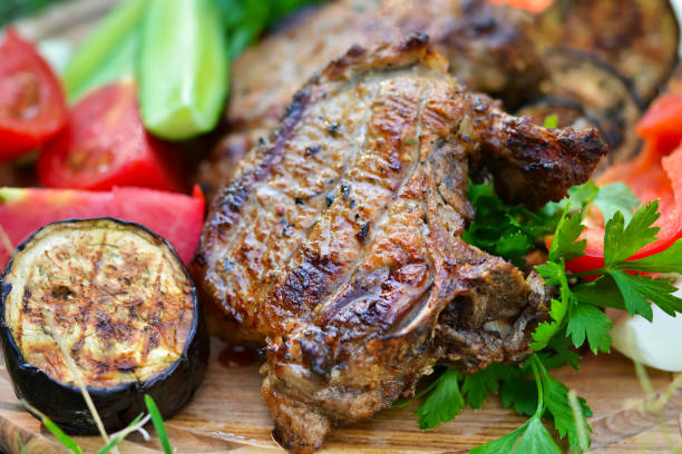 istock Beef steaks grilled with eggplant, tomatoes and peppers. 652722808