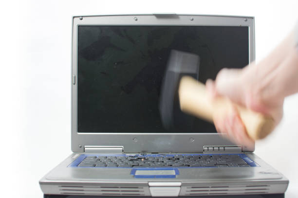 istock Sledgehammer about to smash a laptop keyboard. 652730632
