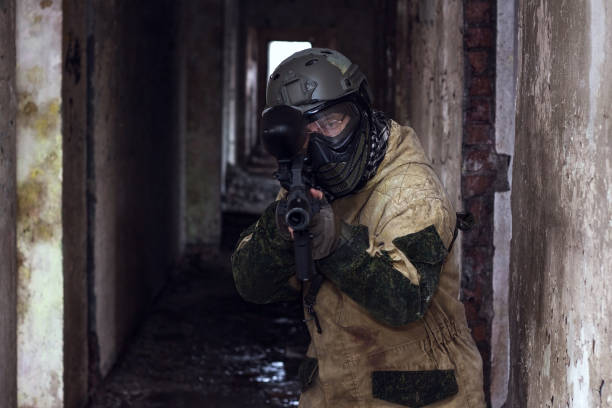 istock Warrior in military camouflage takes aim with gun 652746720