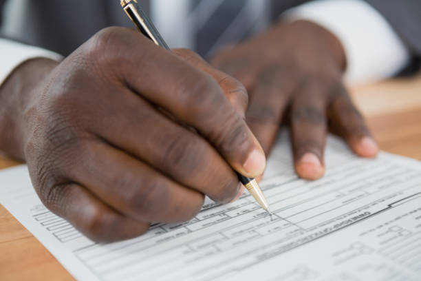 istock Hands of a man signing document 652757660