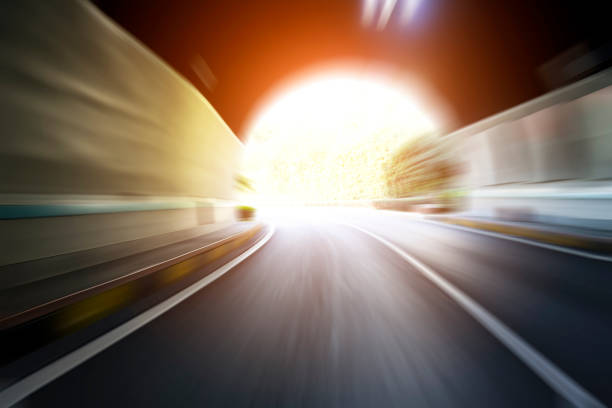 Cars driving out of the tunnel.