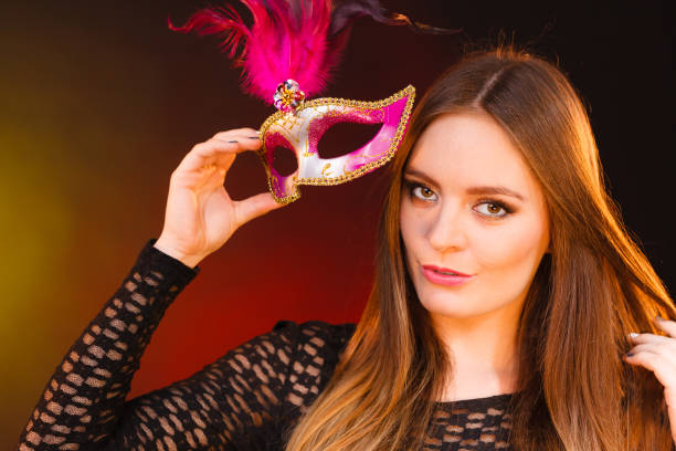 istock Woman holds carnival mask closeup 652761556