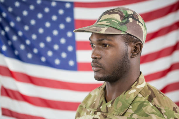 istock Soldier standing against american flag 652764220