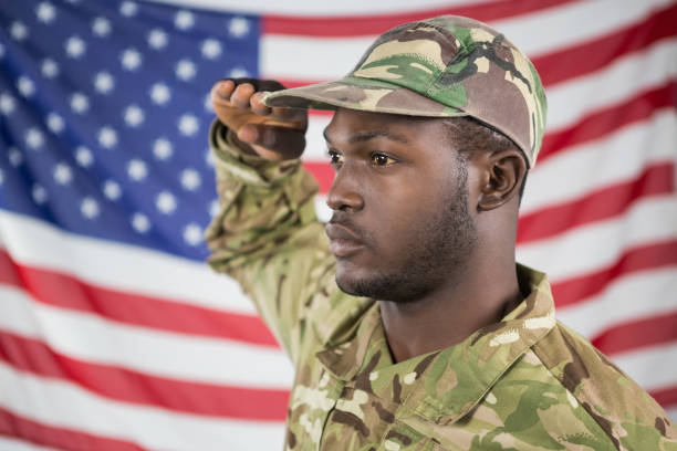 istock Soldier saluting against american flag 652764248