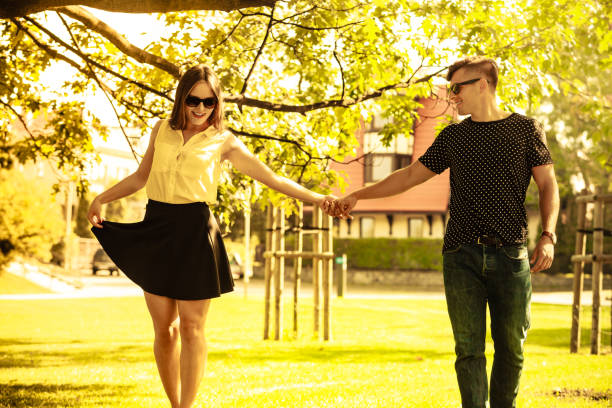 istock Couple holding hands in park. 652764410