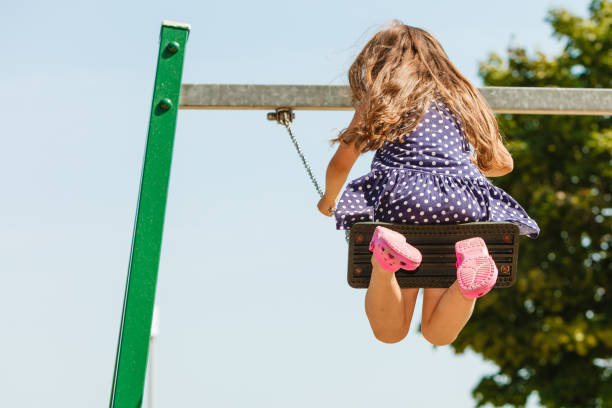 istock Girl swinging on swing-set. 652765600