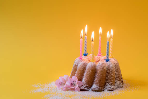 Homemade lemon bundt cake with icing sugar and burning candles Homemade lemon ring cake with icing sugar and burning candles for birthday pound cake stock pictures, royalty-free photos & images