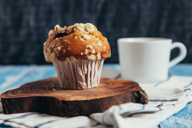 Muffin with berry on wooden table