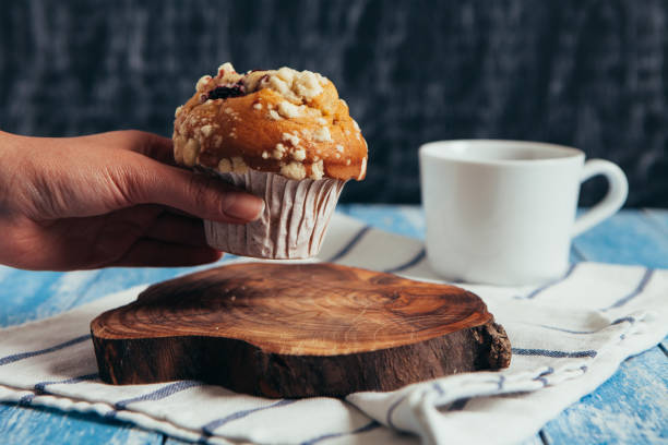 istock Woman grabing a muffin from table 652779234