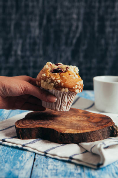 istock Woman grabing a muffin from table 652779356