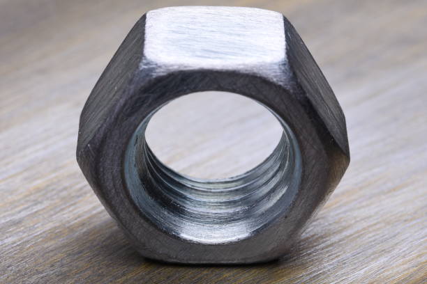 istock Single Steel Nut on Metal Background Closeup 652780226