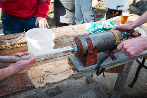 filling sausage skin with sausage meat - sausagemeat imagens e fotografias de stock