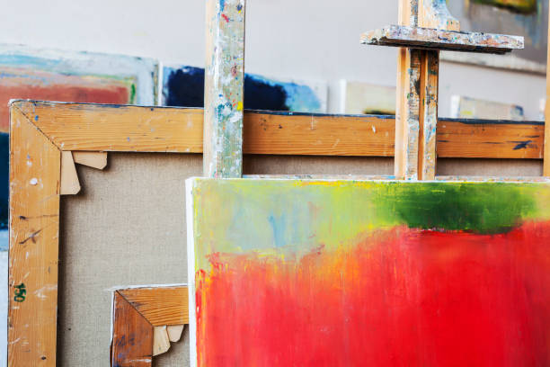 istock Painters studio with easel canvas and painting in progress. 652788764