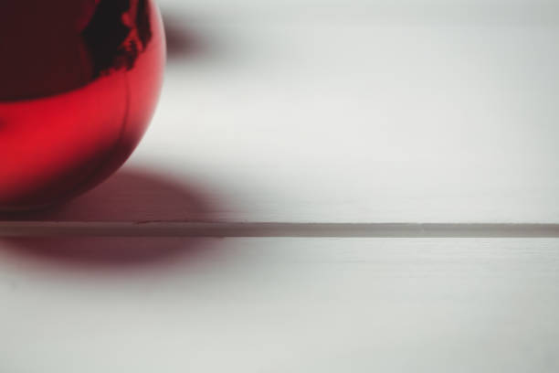 istock Red christmas bauble on wooden table 652792452