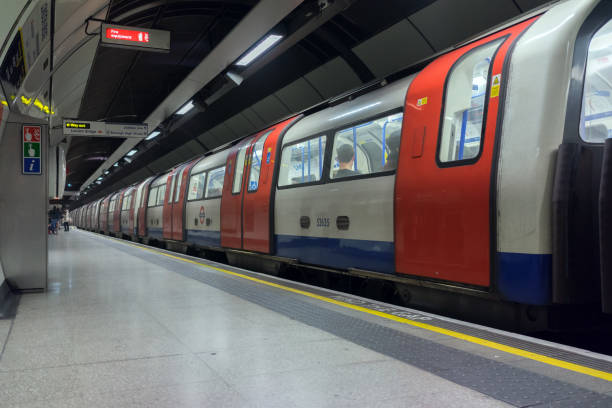 London, UK. 12th March 2017. A London Underground tube train at London Bridge station on the Northern Line.  A few passengers are waiting for the next train in the distance.