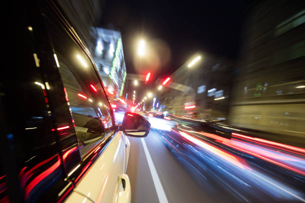 istock Car driving in city at night, blur motion 652795726