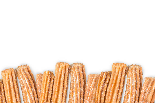 Churros arranged in row isolated on white background stock photo