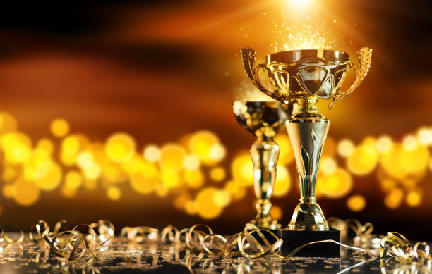 istock Champion golden trophy on wood table with spot lights on background 652798582