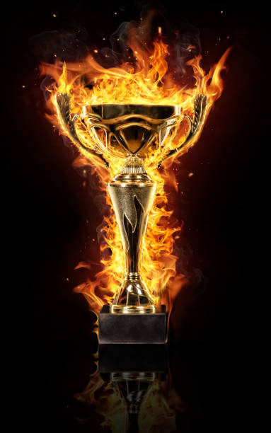 istock Burning gold trophy cup on black background 652798712