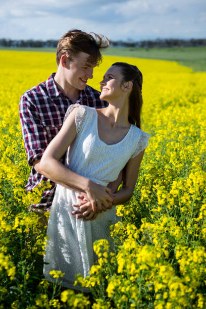 istock Romantic couple standing in mustard field 652799542