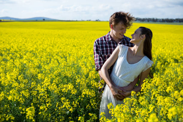 istock Romantic couple standing in mustard field 652799556