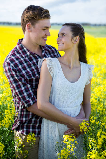 istock Romantic couple standing in mustard field 652799562