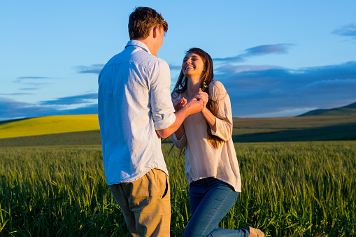 Couple having fun in field on a sunny day