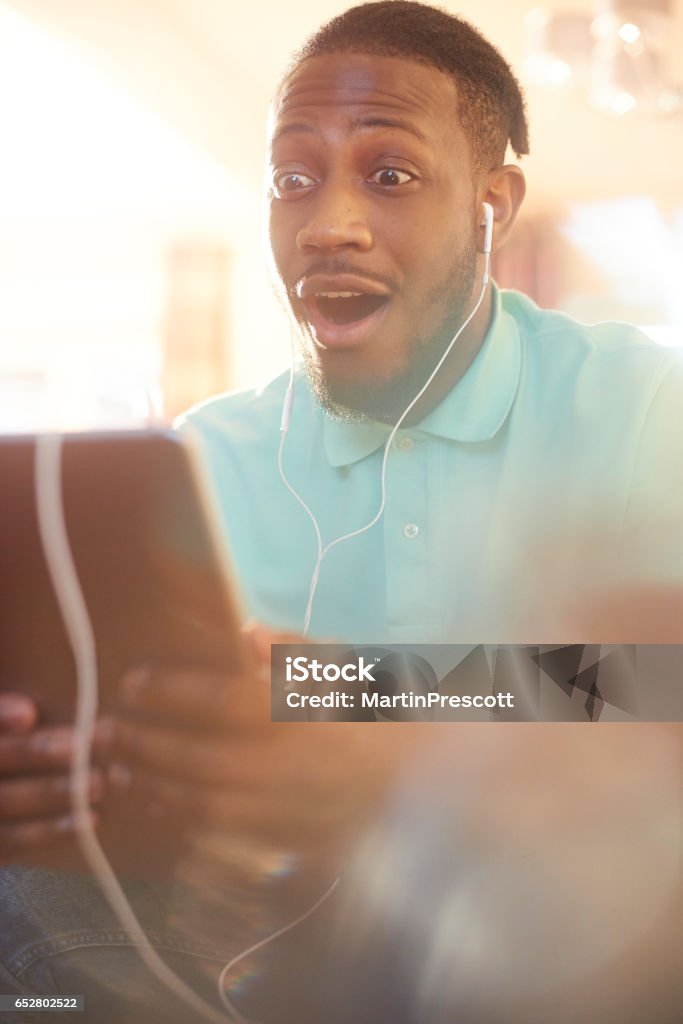 Listening To A Friends Funny Story On A Video Call Stock Photo - Download  Image Now - Watching TV, Video Call, African Ethnicity - iStock