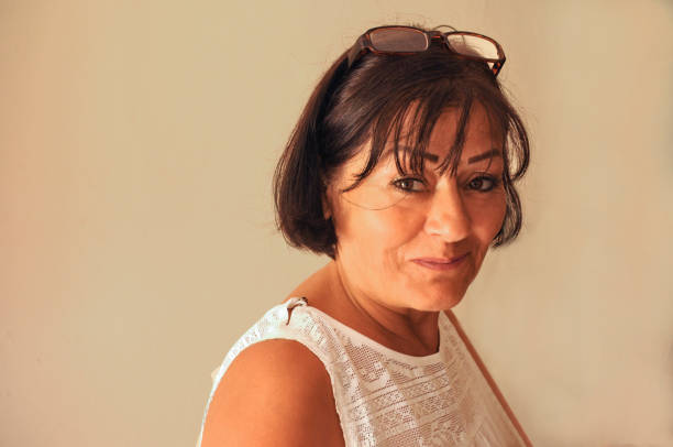 istock middle aged shy woman smiling 652802556