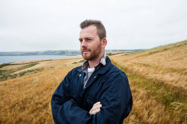 istock Farmer standing with arms crossed in the field 652806330