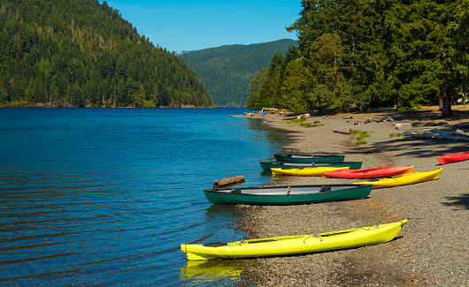 Canoes and kayaks on the beach at Crescent Lake on Washingtonâs Olympic Peninsula