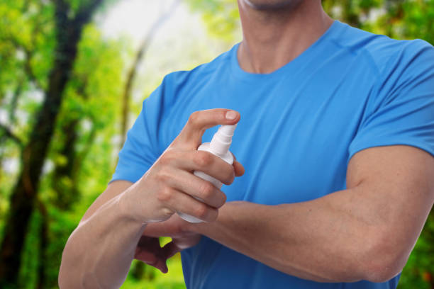 istock Mosquito repellent. Male using insect repellent spray from bootle in forest. 652808984
