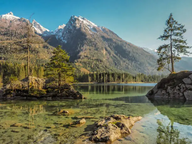 Lake Hintersee at Berchtesgadener Land district with mountains covered with snow in the background, Bavaria, Germany